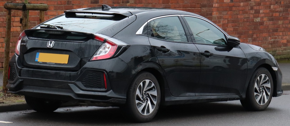 Rear and side view of a modern black hatchback with alloy wheels