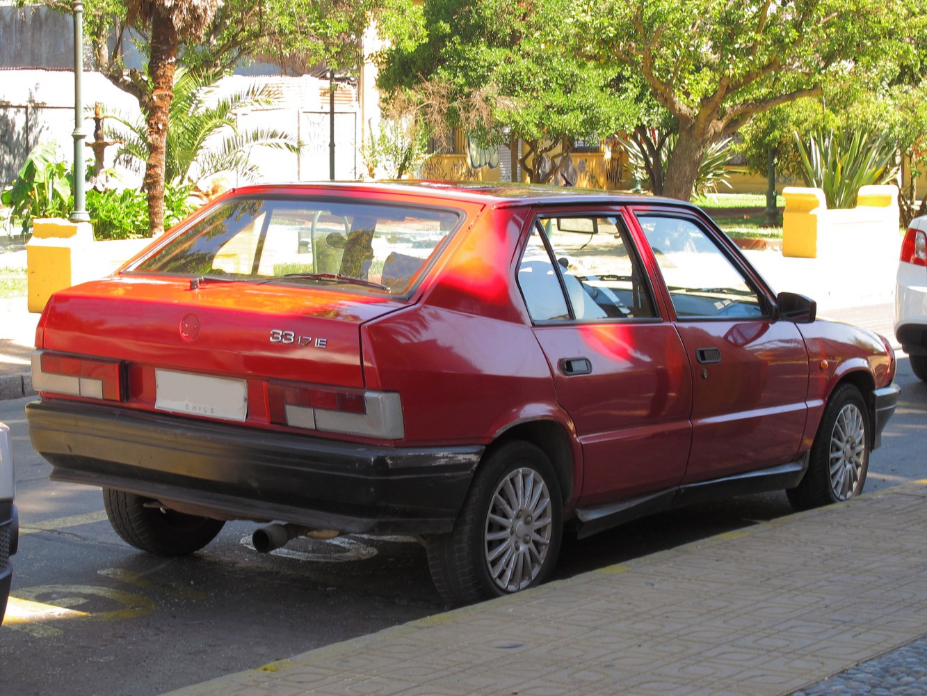 Rear side view of red classic 1980s hatchback