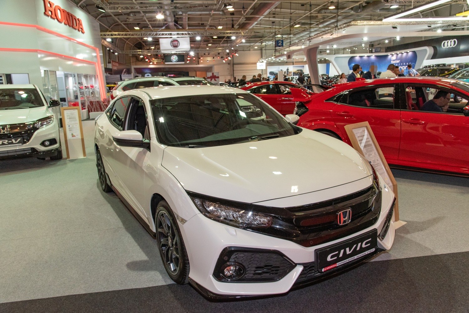 White car front view with aggressive headlights and sporty design