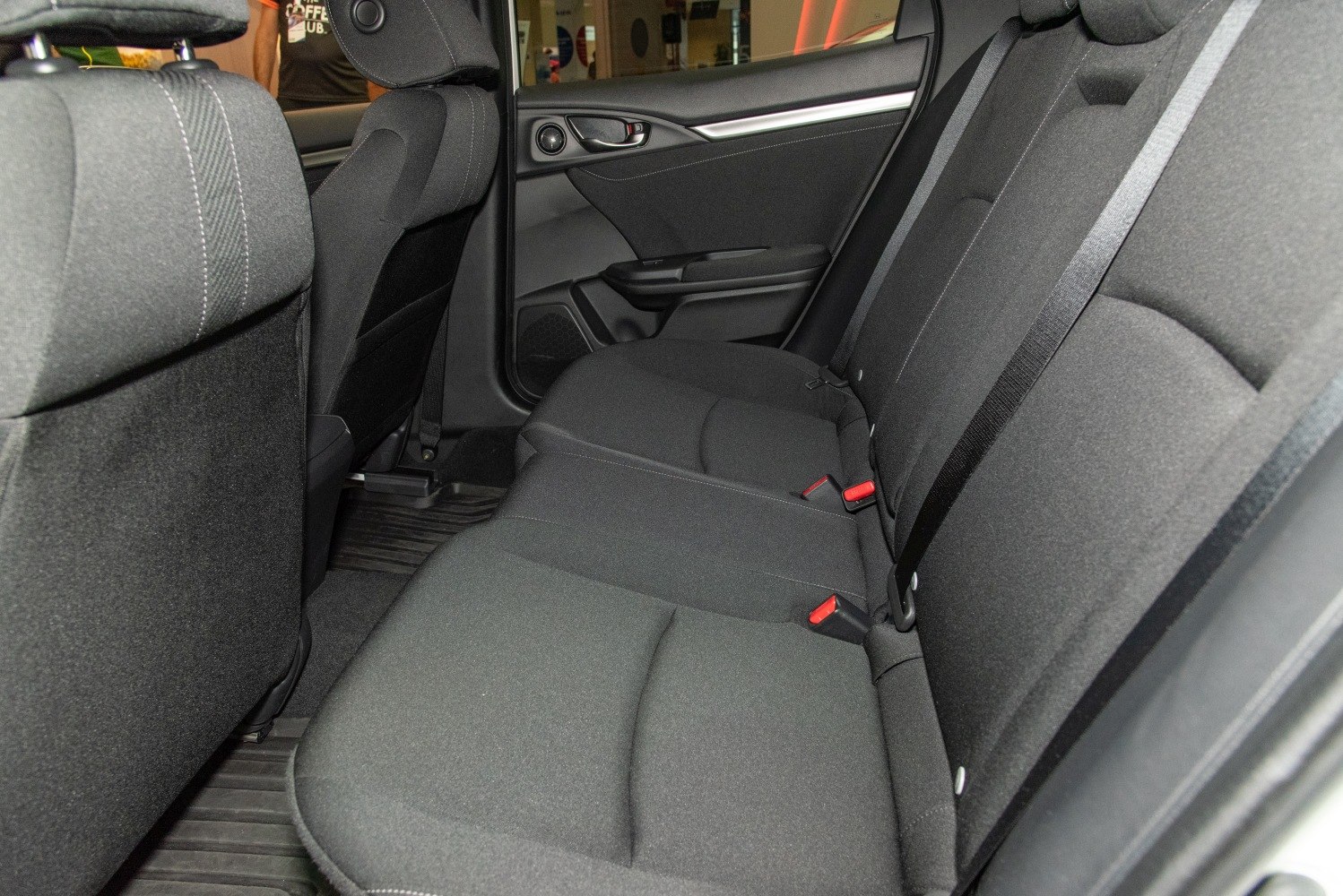 Rear seat with black fabric upholstery and door panel interior