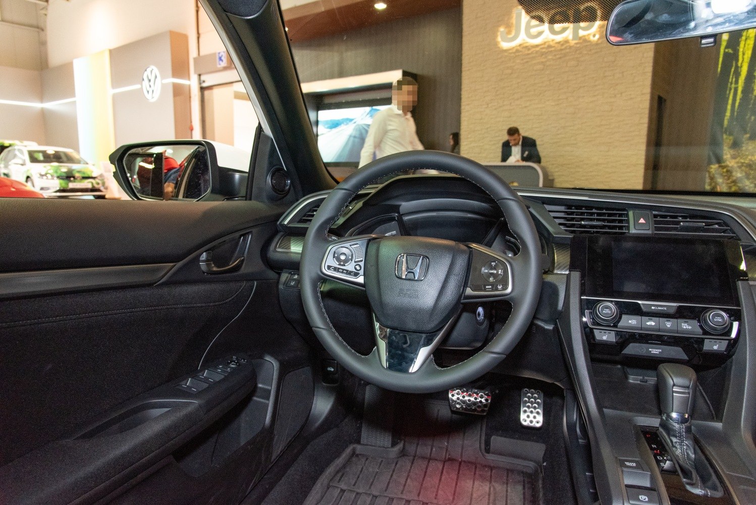 Steering wheel and dashboard interior view with center console and controls