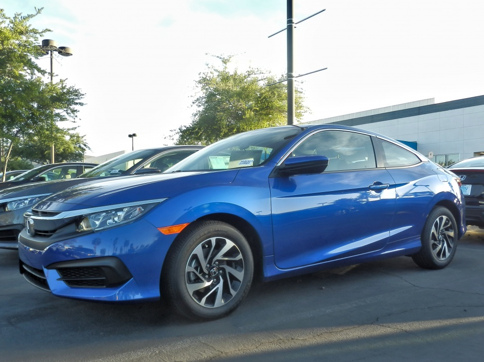 Blue coupe with alloy wheels and sleek headlights