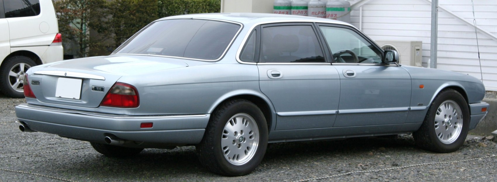 Rear and side view of classic luxury sedan with alloy wheels