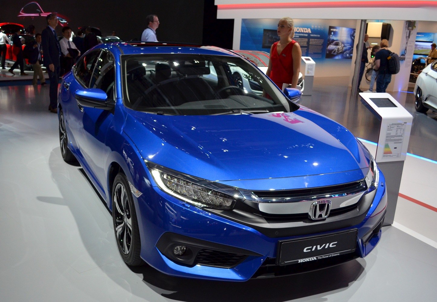 Front view of a blue sedan with distinctive headlights and grille