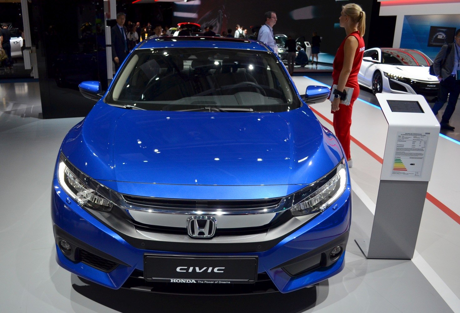 Front view of blue sedan with LED headlights and chrome grille