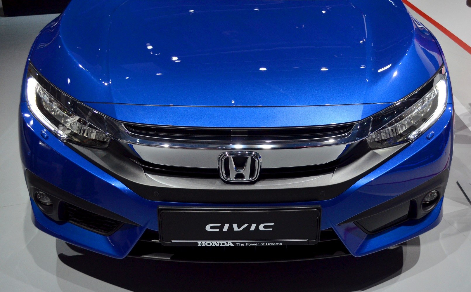 Close-up of front grille and LED headlights in blue vehicle front.