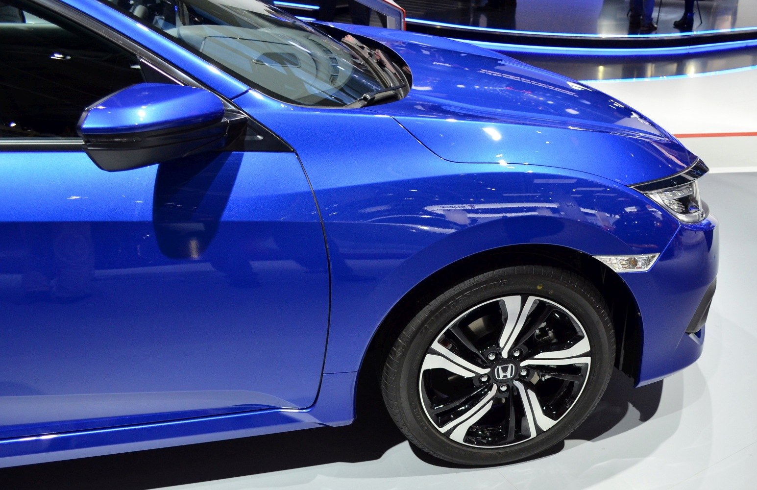 Front fender and modern multi-spoke alloy wheel close-up