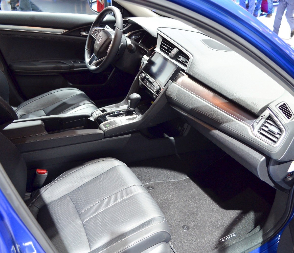 Modern dashboard, touchscreen display, leather front seats