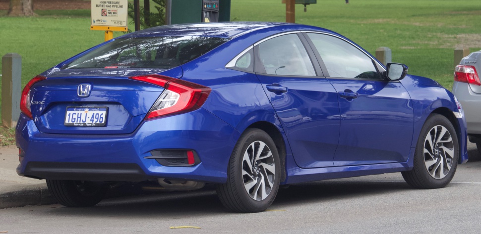 Rear side view of a blue sedan with distinctive taillights and alloy wheels