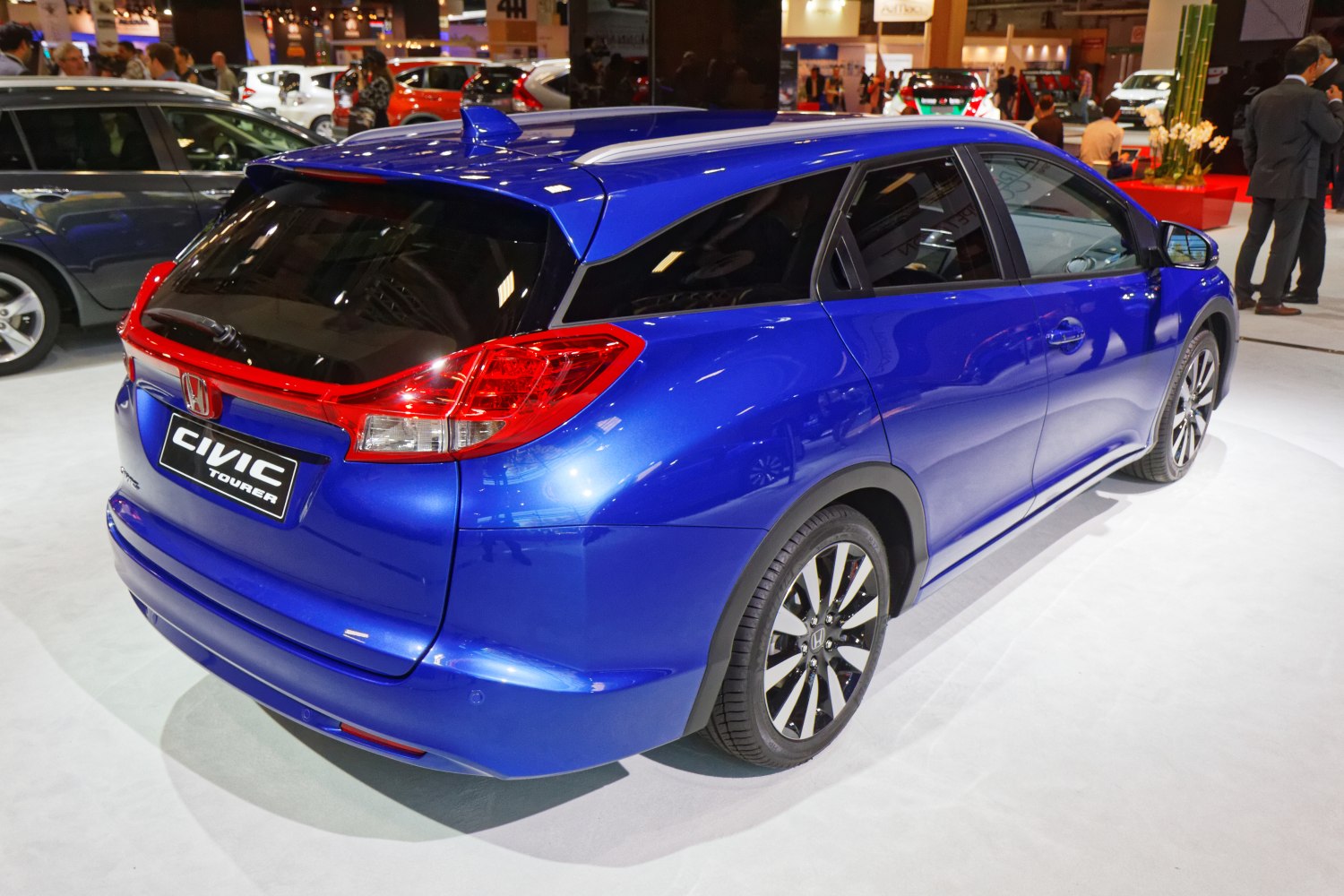 Rear and side profile of a blue hatchback with distinctive taillights and alloy wheels