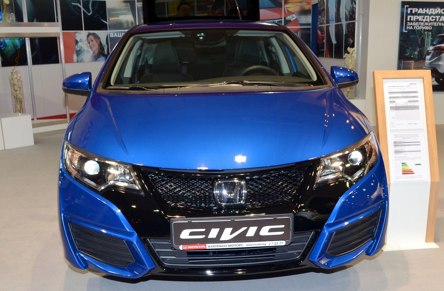 Blue car front with grille and headlights