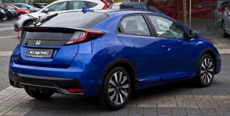 Rear view of hatchback with distinctive taillights and multi-spoke alloy wheels