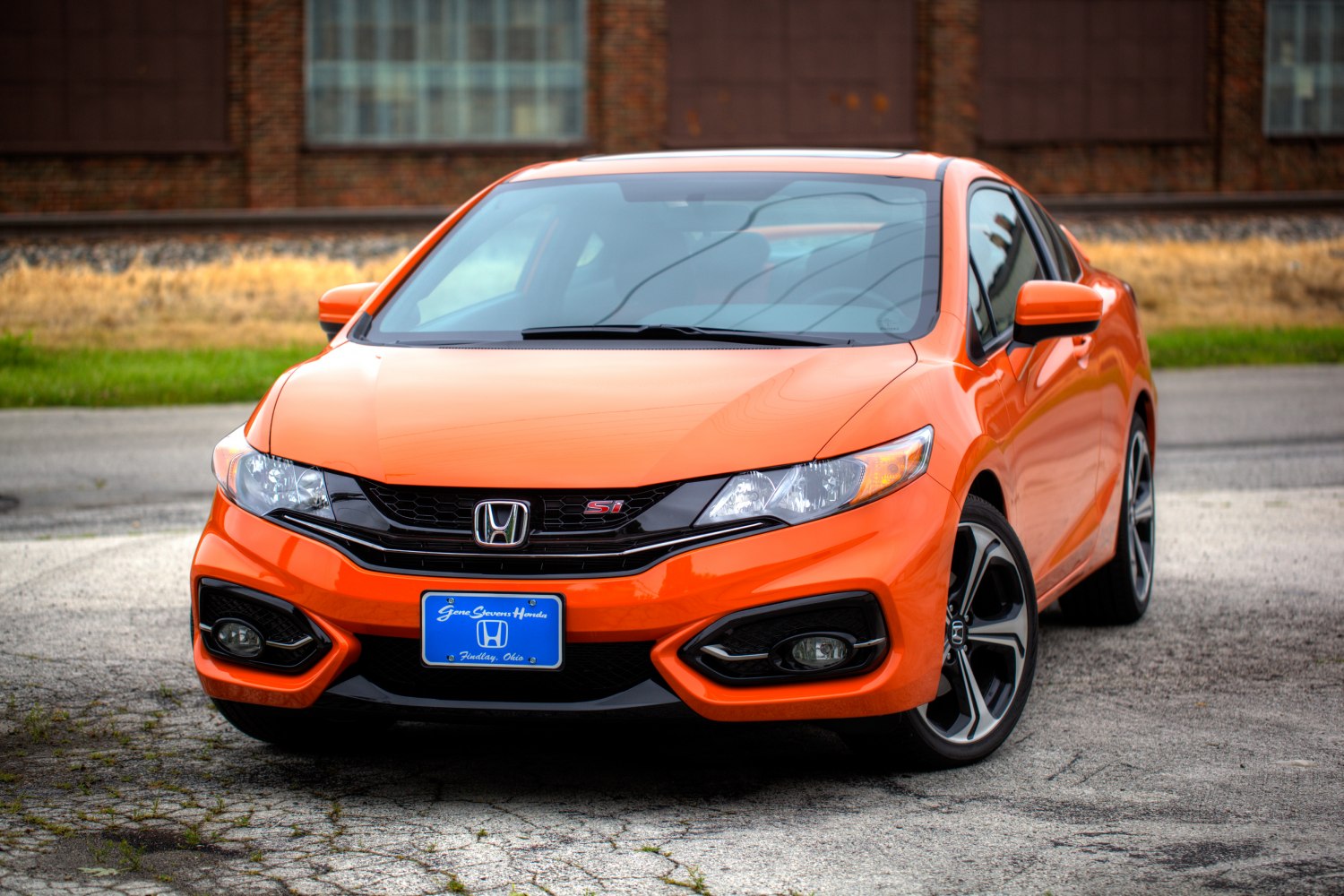 Front view of sporty coupe with sleek headlights and sporty grille