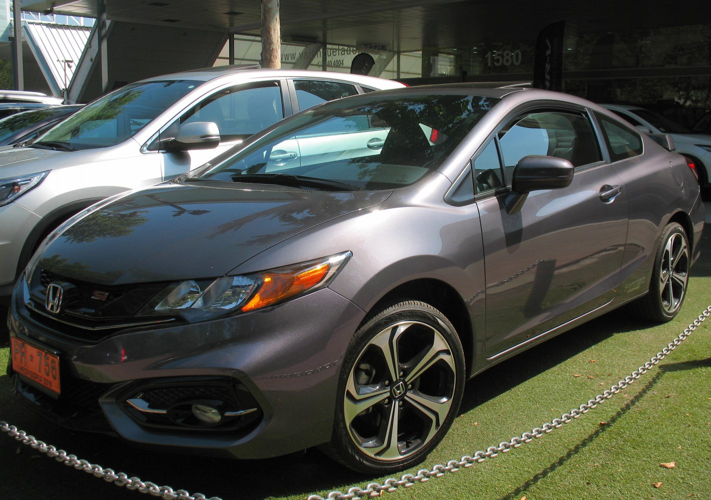 Sporty coupe front with alloy wheels and fog lights