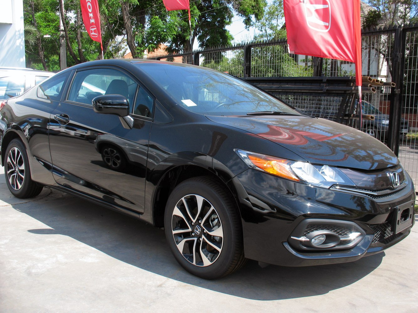 Black coupe with facelift front fascia and alloy wheels
