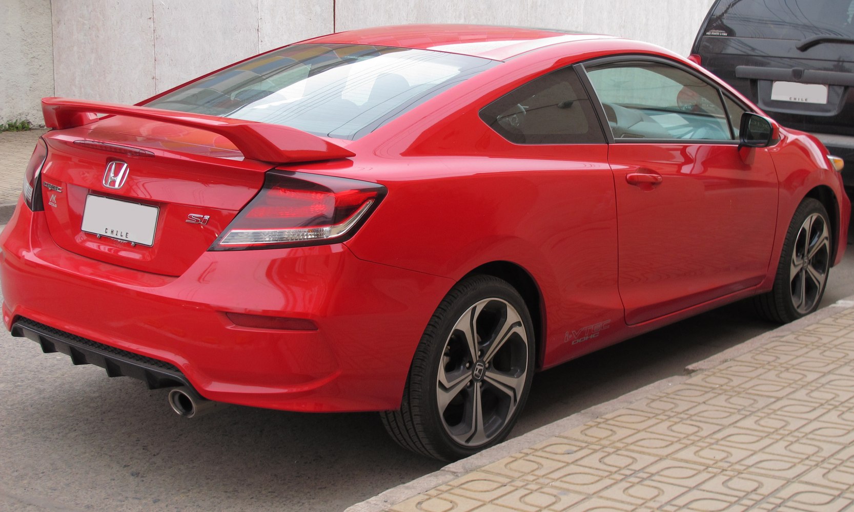 Sporty coupe rear view with spoiler and alloy wheels