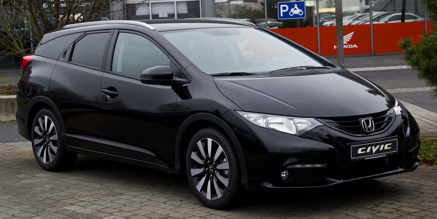 Black station wagon with modern headlights and aerodynamic front design