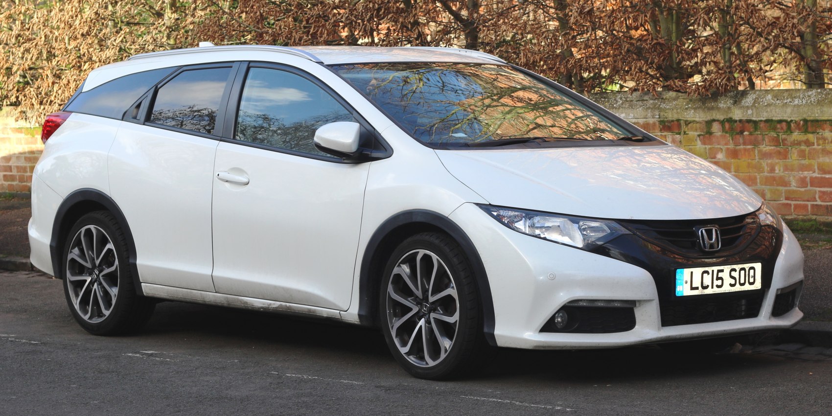 White modern hatchback with alloy wheels front side view.