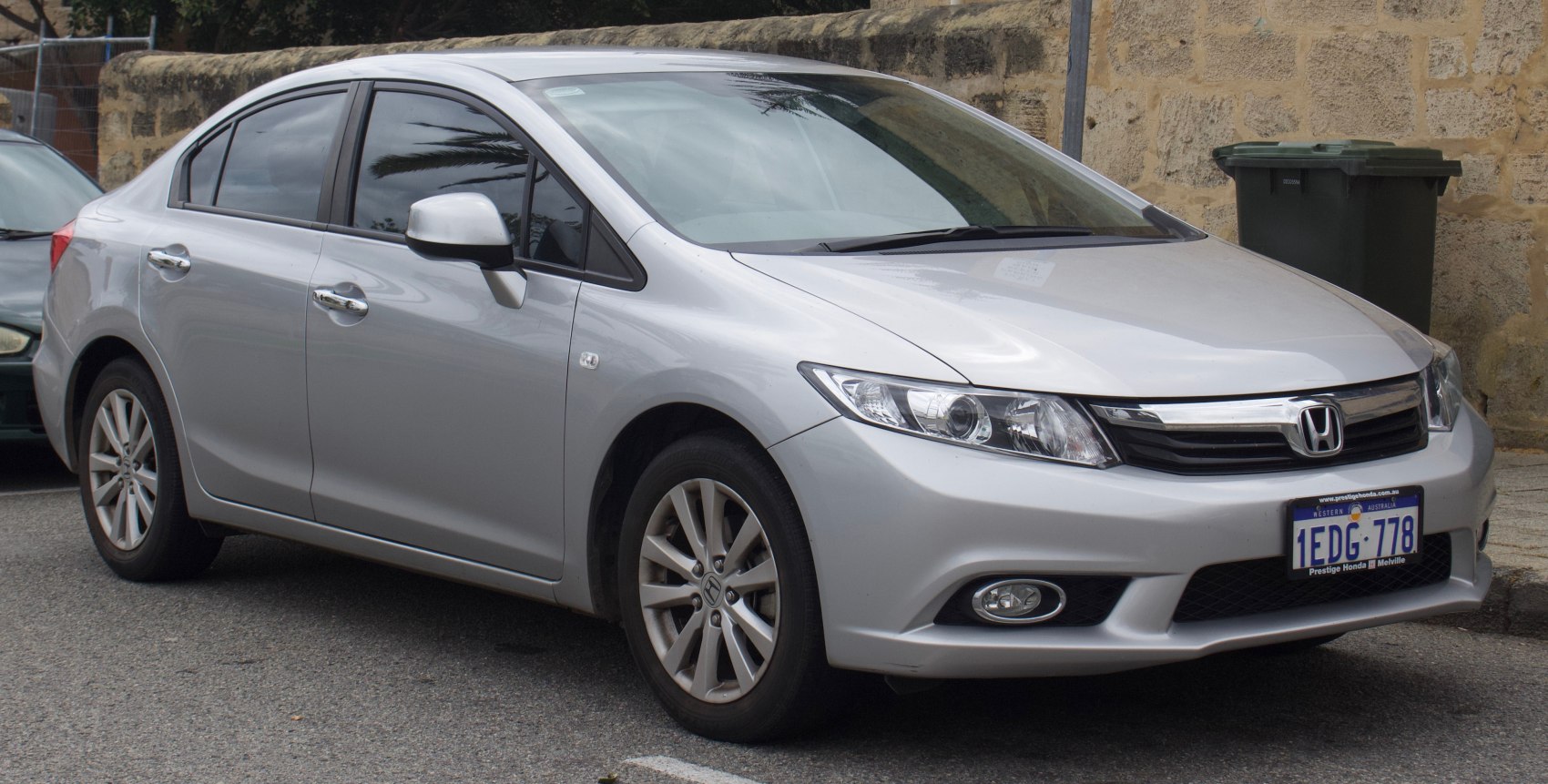 Silver sedan with modern headlights and alloy wheels