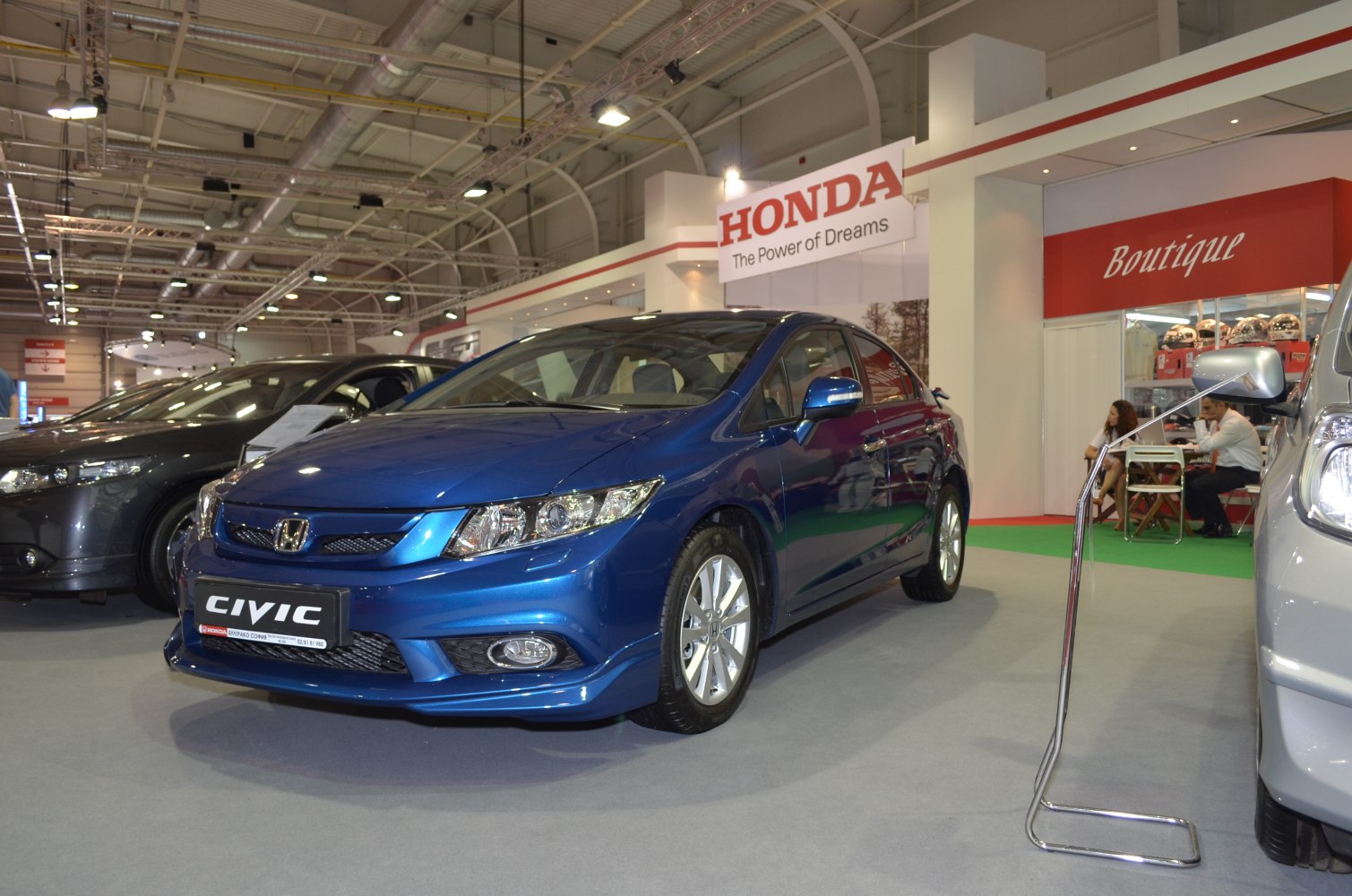 Blue sedan front view with detailed headlights and sporty grille
