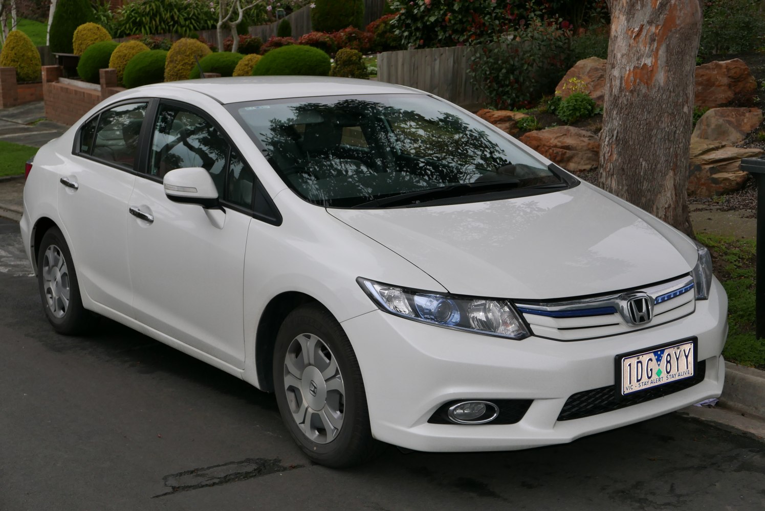 White compact sedan with modern headlights and fog lamps