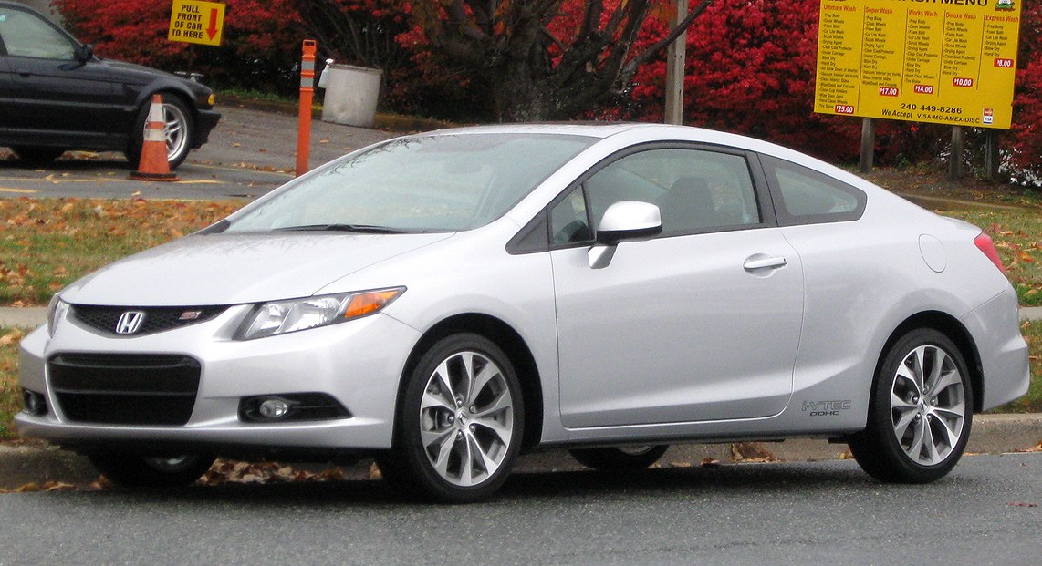 Silver coupe side profile with aerodynamic shape and alloy wheels
