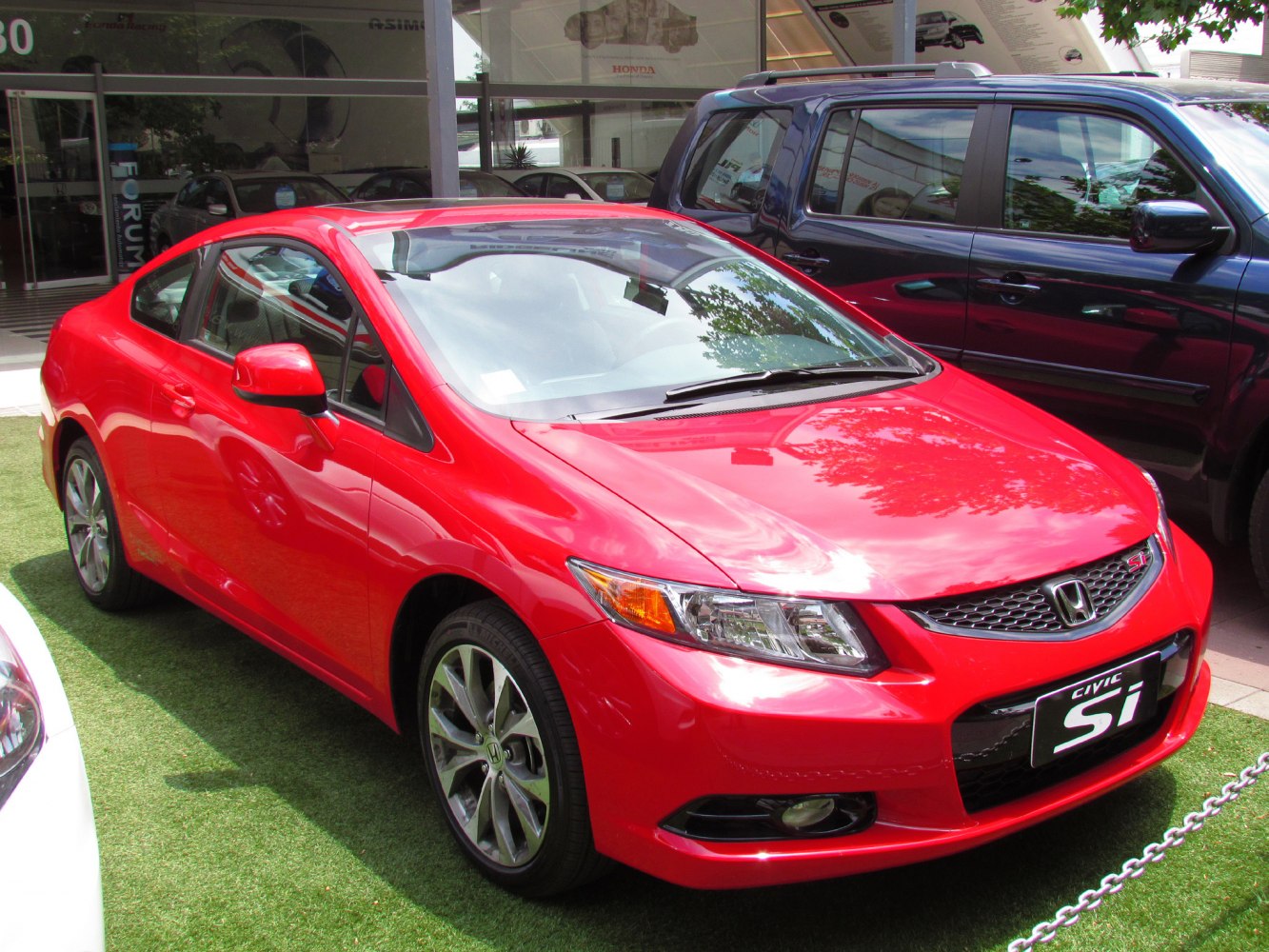 Red coupe with modern LED headlights and alloy wheels