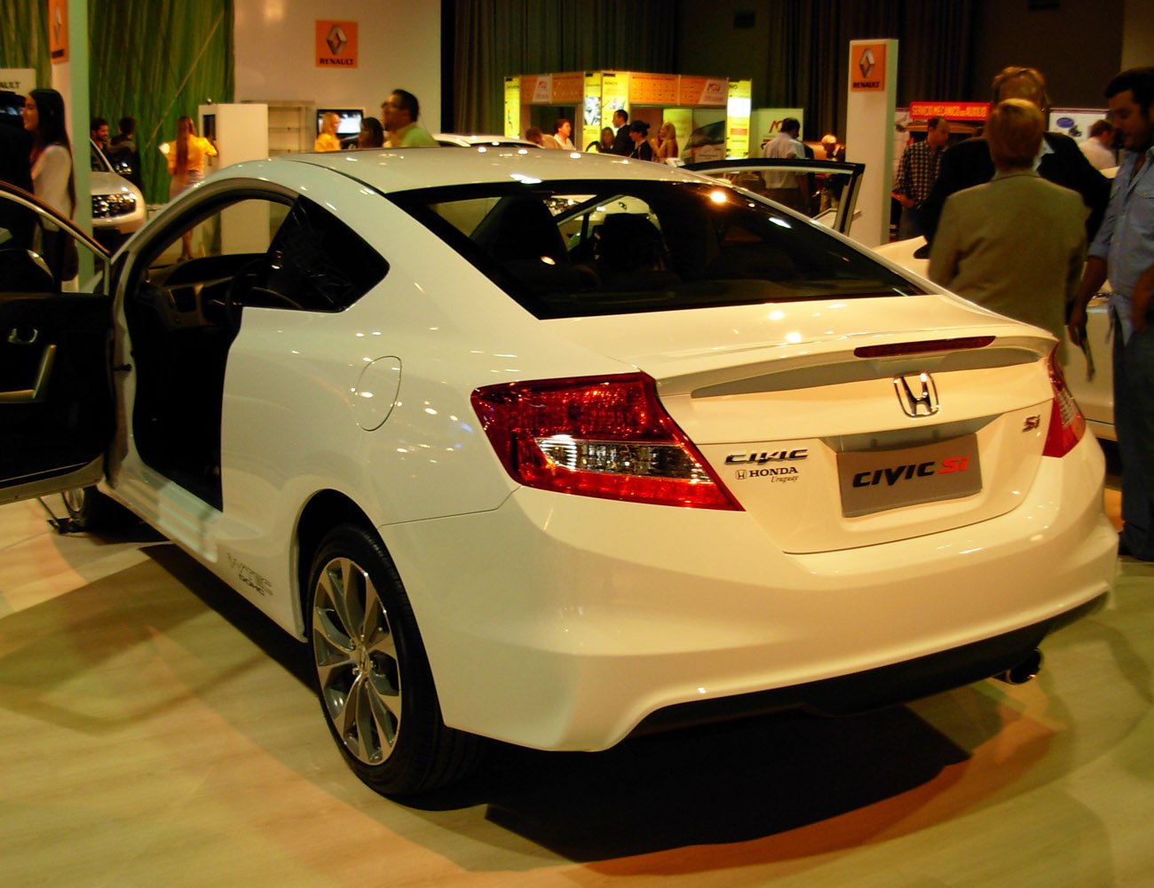 Rear and side view of a white two-door coupe with distinctive tail lights and sporty rear design