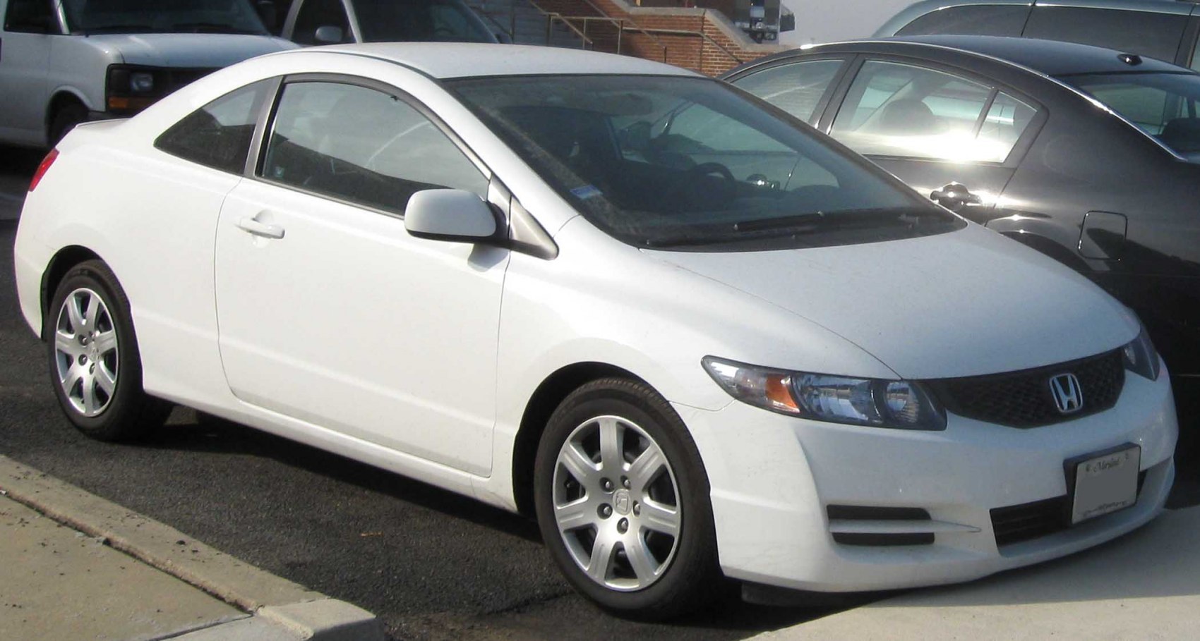 Sporty two-door coupe with sleek front grille and alloy wheels