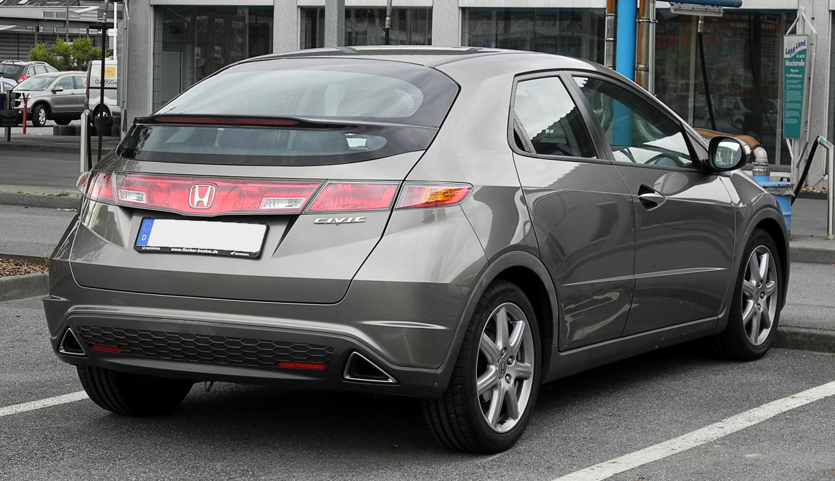 Distinctive rear with elongated tail lights and triangular exhaust accents