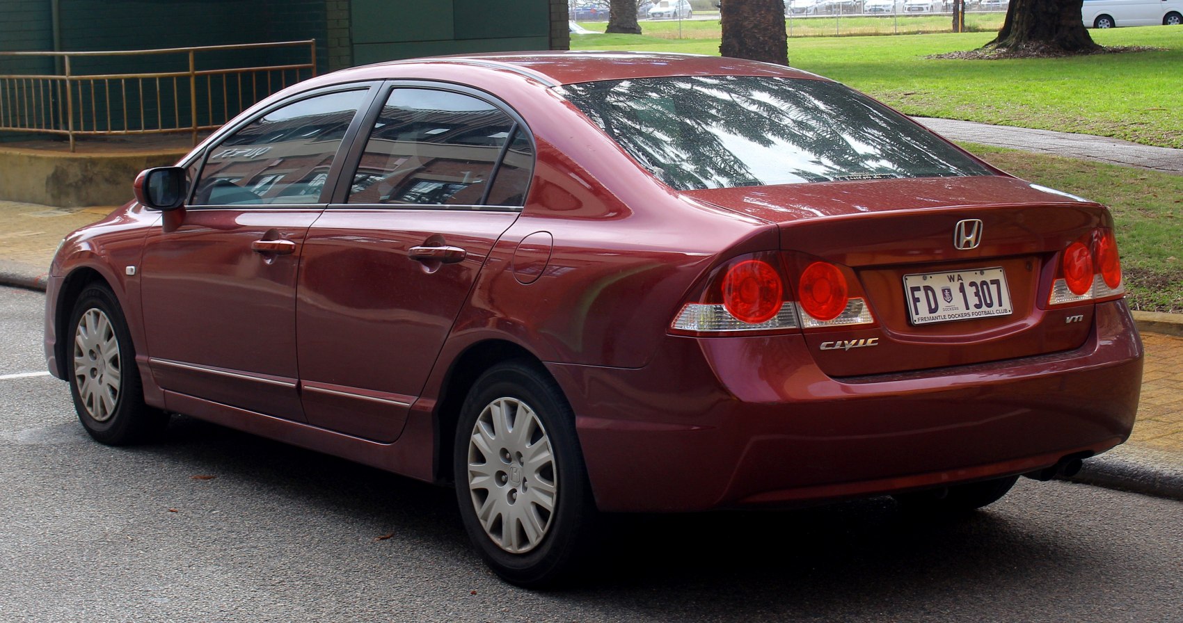 rear side view, tail lights, four-door sedan