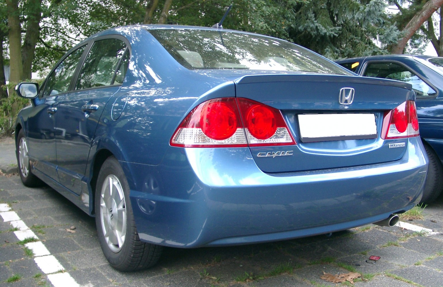 Rear and side view with distinctive taillights and hybrid badge