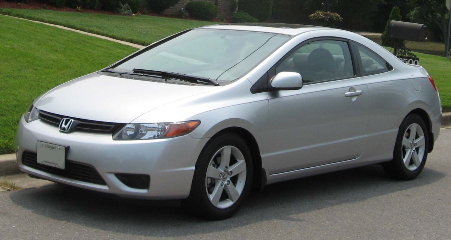 Silver two-door compact coupe with alloy wheels and aerodynamic body