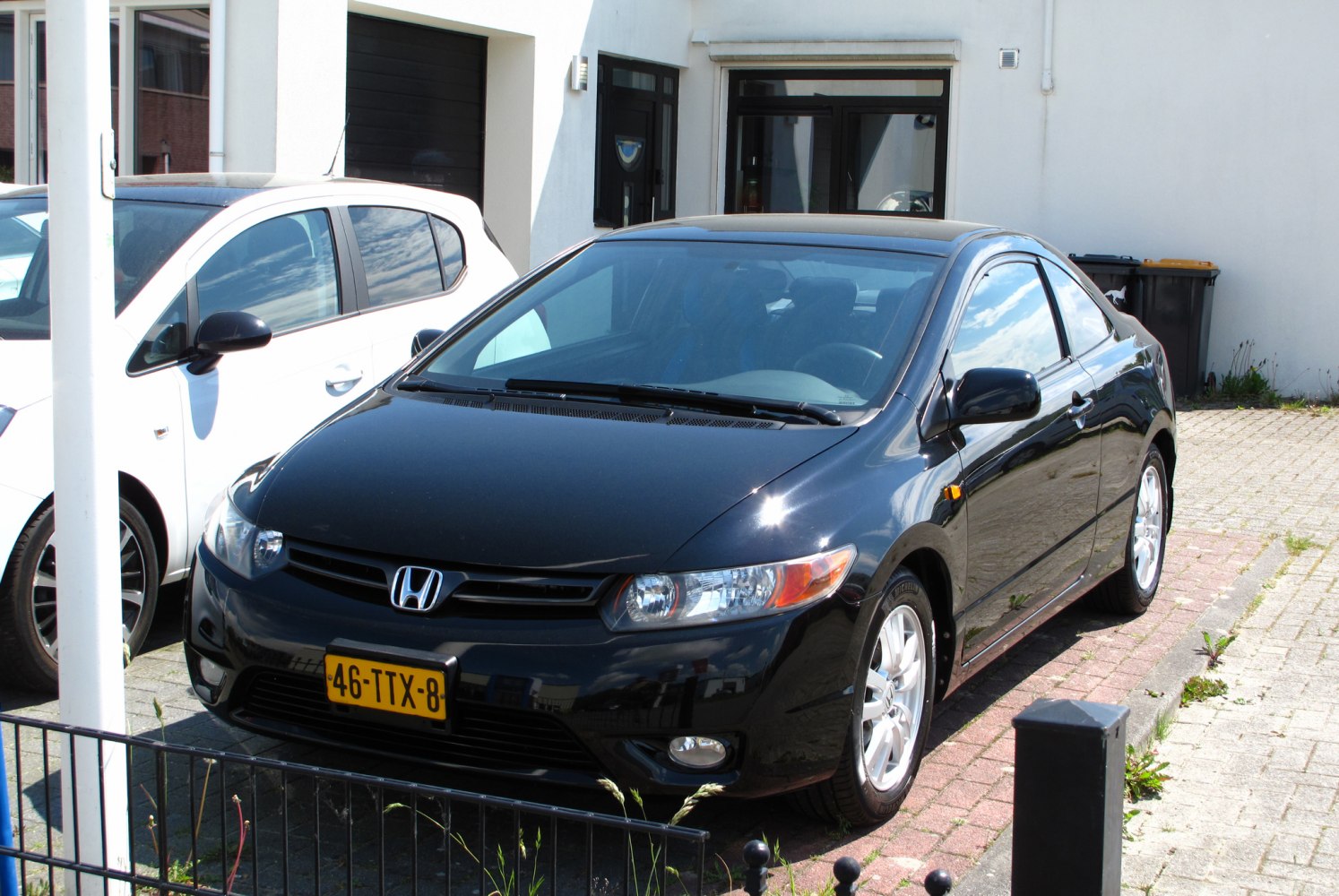 Front side view of a black two-door coupe with aerodynamic design
