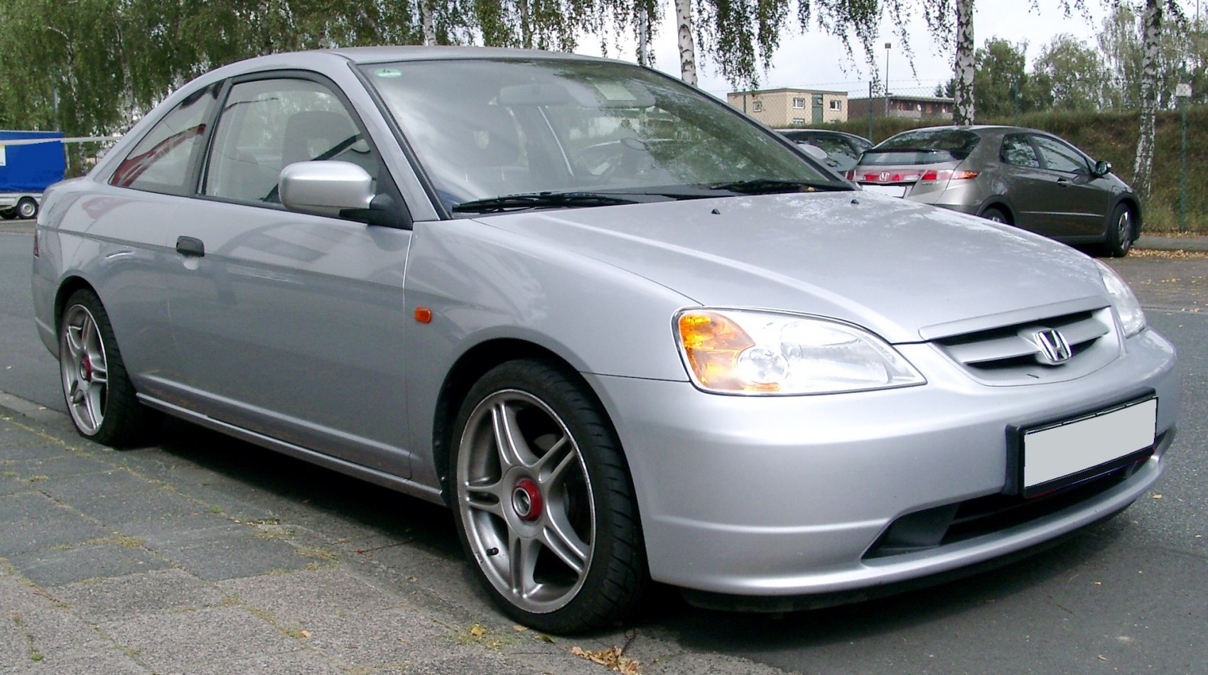 Silver coupe with sporty alloy wheels and clear headlights