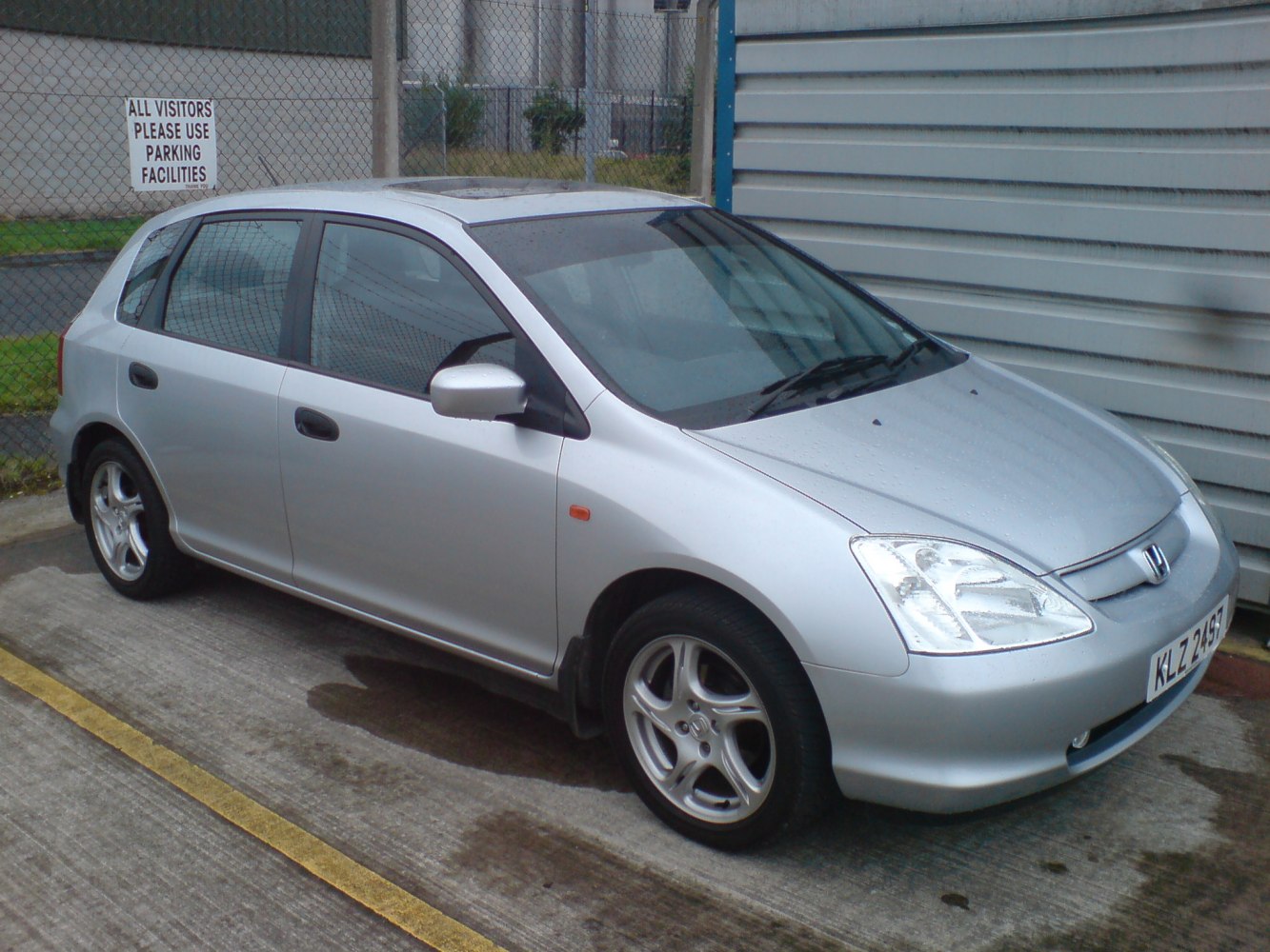 Silver 5-door hatchback with alloy wheels and sunroof front side view