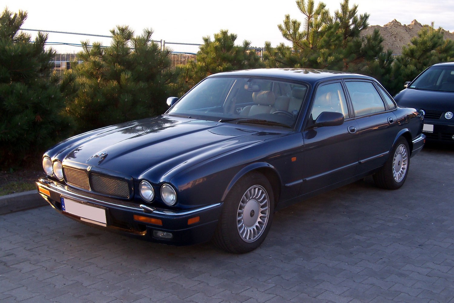 Dual round headlights and classic front grille of luxury sedan