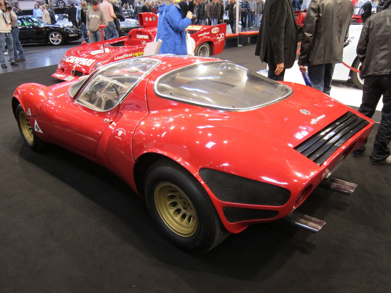 Red sports coupe with curved rear window and gold wheels
