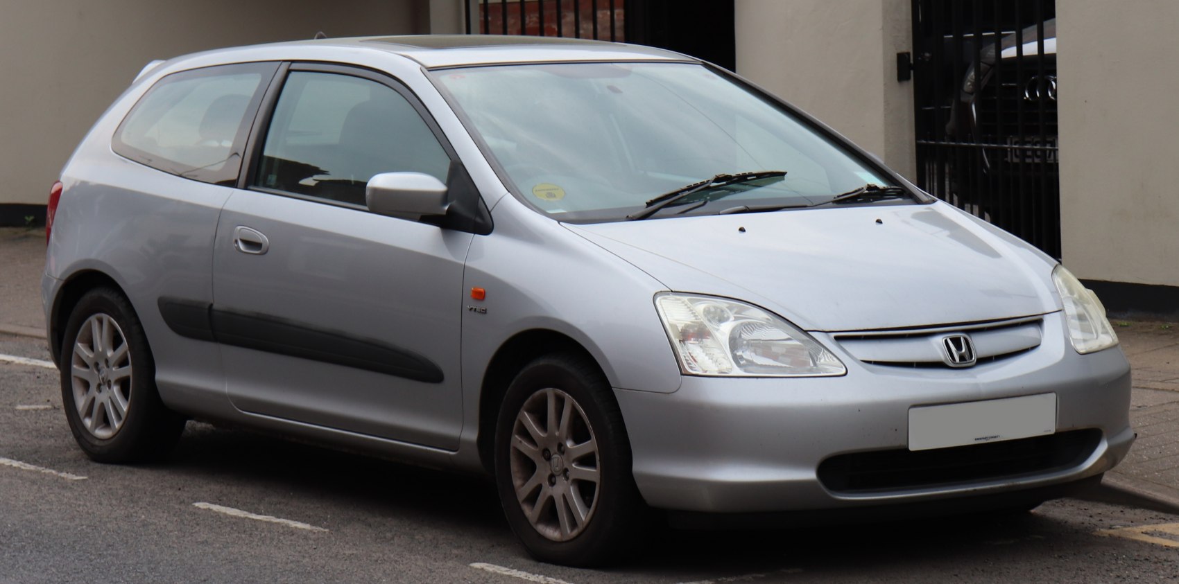 Silver hatchback with triangular headlights and compact aerodynamic shape