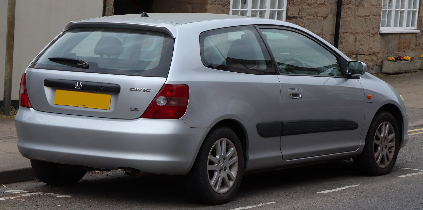 Rear three-quarter view of hatchback with distinct taillights and rear wiper