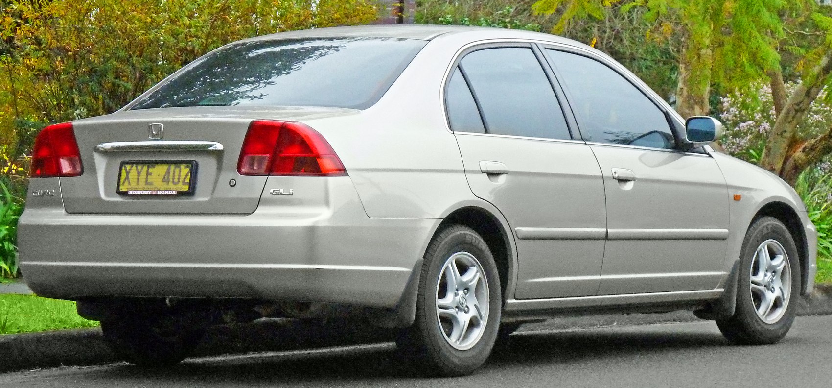 Rear and side view of silver sedan with alloy wheels