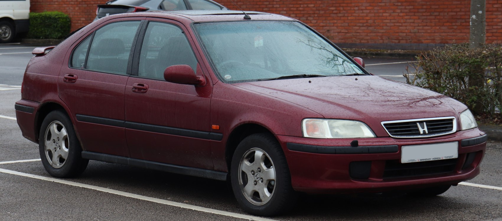 Front quarter view with headlights, grille, and alloy wheels