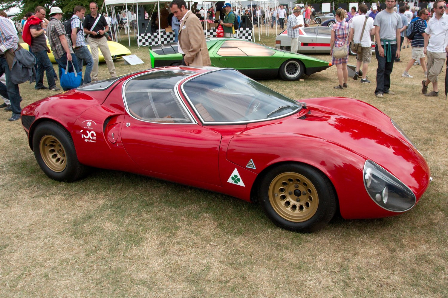 Aerodynamic sports coupe with teardrop headlights and gold alloy wheels
