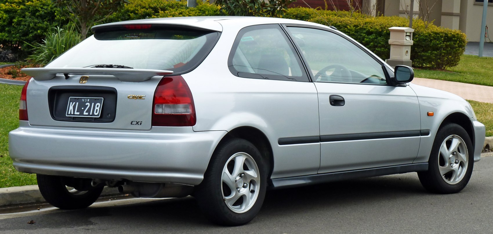 Silver hatchback with rear spoiler and alloy wheels