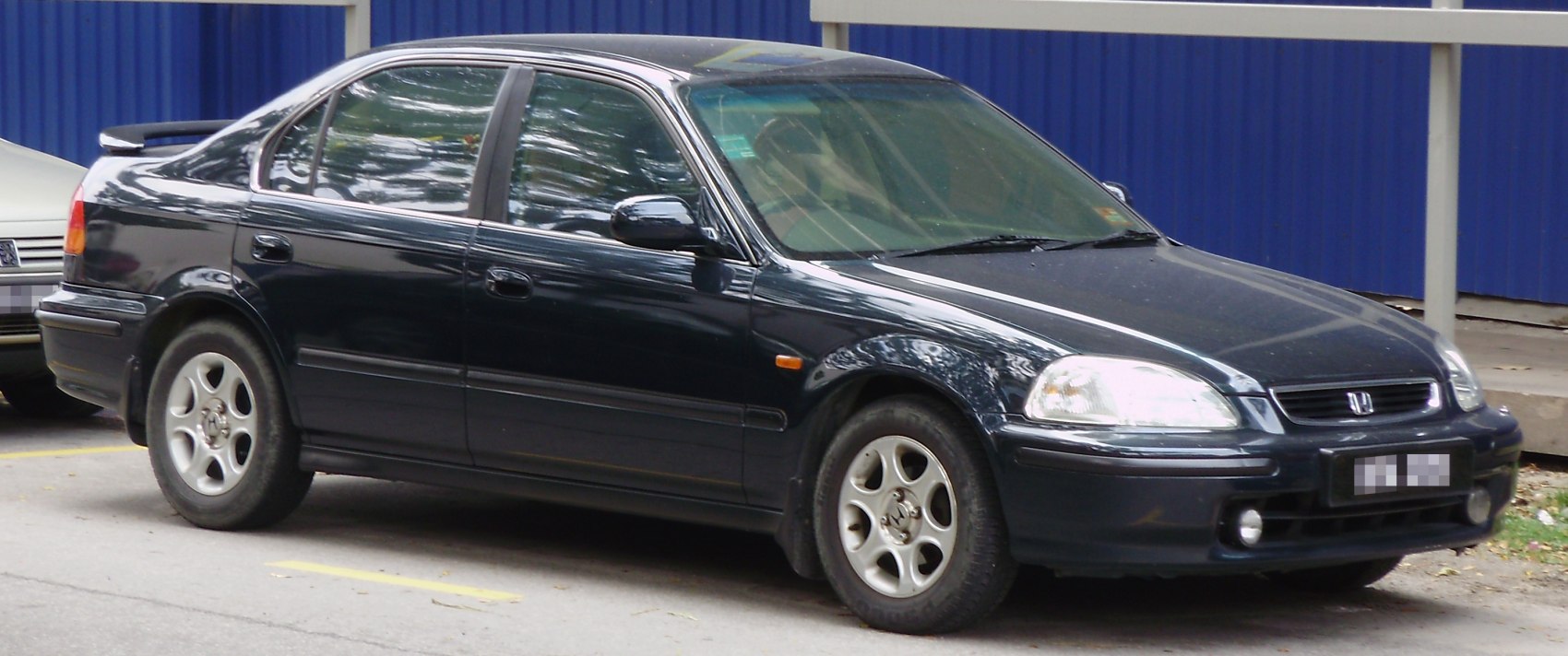 Front-side exterior of black four-door sedan with alloy wheels