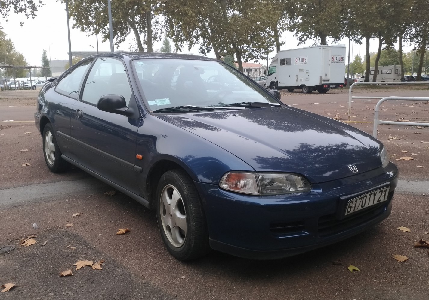 Front side view of 1990s two-door coupe with sleek headlights and aerodynamic lines