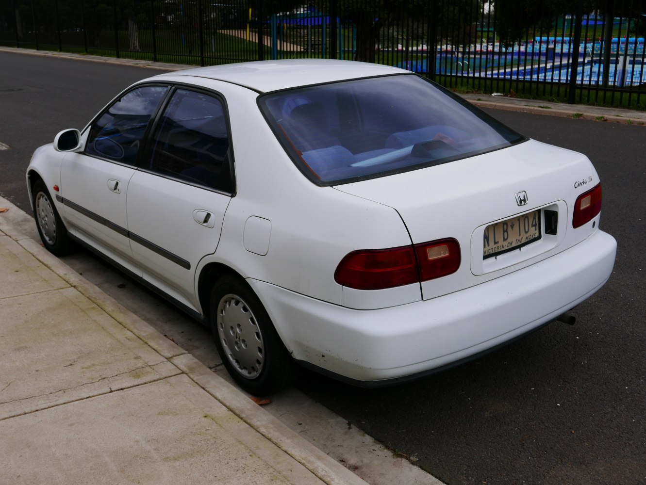 Rear three-quarter view of classic sedan with visible taillights and body shape