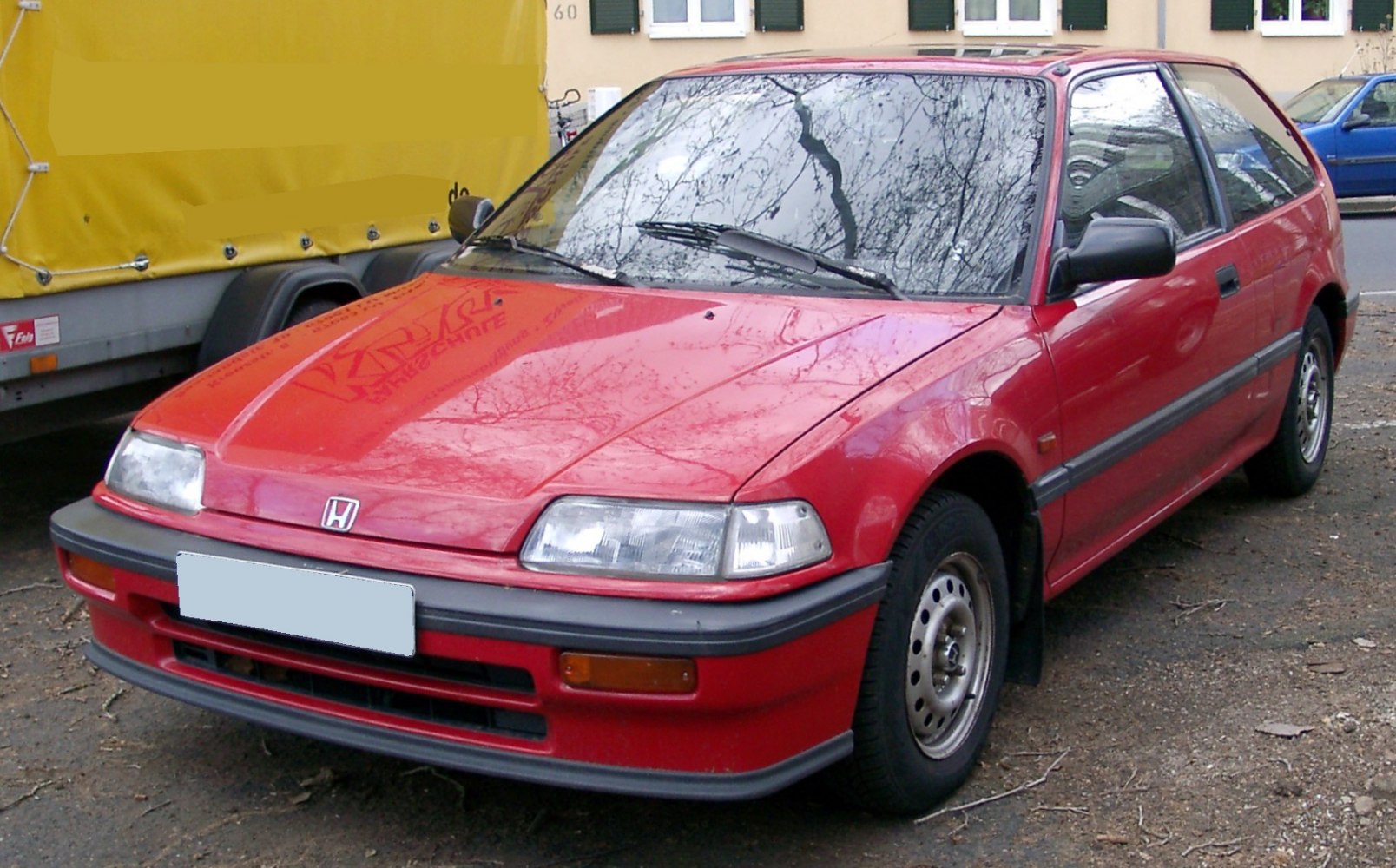 Rectangular headlights and steel wheels on 1980s hatchback front-side view