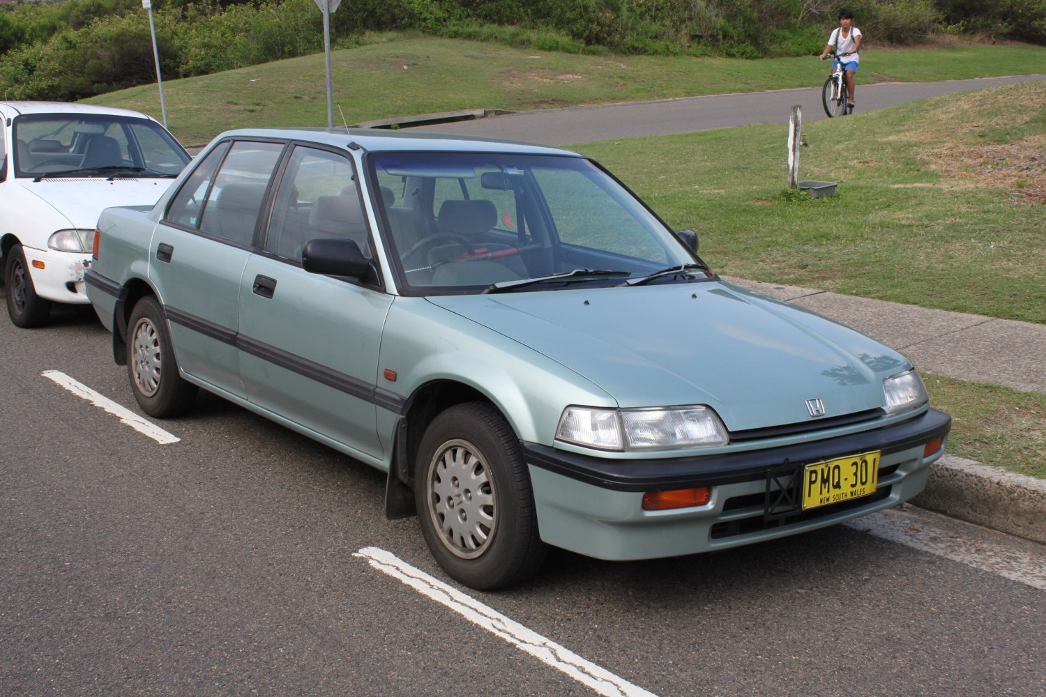 Front-side view of vintage sedan with rectangular headlights and simple body lines