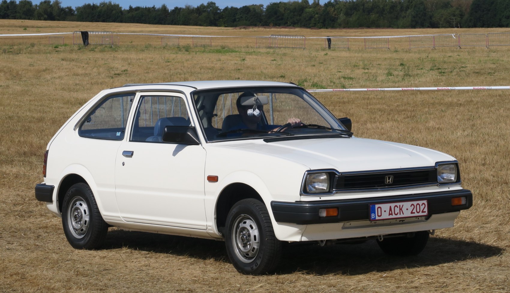 White vintage hatchback with square headlights and angular design, reflecting late 70s automotive style.